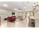Spacious living room with tile floors, neutral paint, tray ceiling, recessed lighting, and comfortable seating at 9617 Sw 102Nd Ter, Ocala, FL 34481