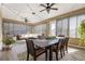 Beautiful, screened-in porch featuring modern furniture, decorative string lights, and stylish rugs at 9617 Sw 102Nd Ter, Ocala, FL 34481