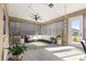 Relaxing screened-in patio featuring comfortable seating, ceiling fans, and inviting string lights at 9617 Sw 102Nd Ter, Ocala, FL 34481
