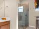 Walk-in shower with built-in seat, glass enclosure, and pebble stone floor at 9617 Sw 102Nd Ter, Ocala, FL 34481