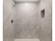 Walk-in shower with grey tile and built-in niche at 13526 Sw 106Th Pl, Dunnellon, FL 34432