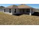 Rear view of a home with a covered patio and a spacious lawn at 4557 Ne 31St St, Ocala, FL 34470