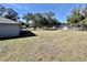 Spacious backyard enclosed by a fence with mature trees providing shade at 9285 Se Highway 42, Summerfield, FL 34491