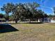 Fenced backyard, shaded by mature trees, offering lots of outdoor living space at 9285 Se Highway 42, Summerfield, FL 34491