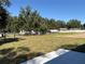 Large grassy backyard with a fence, offering a private space for outdoor activities and relaxation at 9285 Se Highway 42, Summerfield, FL 34491