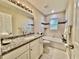 Bright bathroom featuring a granite countertop, white cabinets, and a shower-tub combination at 9285 Se Highway 42, Summerfield, FL 34491