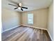 Bedroom features wood-look flooring, ceiling fan, and window at 9285 Se Highway 42, Summerfield, FL 34491
