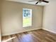 Bedroom featuring wood-look floors and a window with an outside view at 9285 Se Highway 42, Summerfield, FL 34491