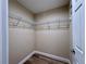 Walk-in closet with shelving and wood-look floors at 9285 Se Highway 42, Summerfield, FL 34491