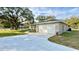 The house features a well-maintained lawn, an attached two-car garage, and a concrete driveway at 9285 Se Highway 42, Summerfield, FL 34491