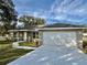 Attractive home with a large garage, stone accents, and a well-maintained lawn at 9285 Se Highway 42, Summerfield, FL 34491