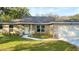 Charming home featuring stone accents, manicured lawn, and a welcoming front entrance at 9285 Se Highway 42, Summerfield, FL 34491