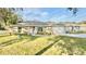 Charming one-story home with a well-manicured lawn, stone accents, and inviting curb appeal at 9285 Se Highway 42, Summerfield, FL 34491
