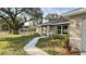 Charming single-story home featuring well-maintained landscaping and a welcoming walkway to the front door at 9285 Se Highway 42, Summerfield, FL 34491