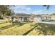 Charming one-story home with a well-manicured lawn, stone accents, and inviting curb appeal at 9285 Se Highway 42, Summerfield, FL 34491