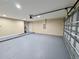 Spacious garage featuring a sealed floor, automatic door opener, and ample room for vehicles and storage at 9285 Se Highway 42, Summerfield, FL 34491