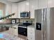 The kitchen features stainless steel appliances, granite countertops, and plenty of storage at 9285 Se Highway 42, Summerfield, FL 34491