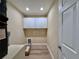Bright laundry room with overhead cabinets and modern fixtures at 9285 Se Highway 42, Summerfield, FL 34491