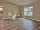 The living room is well-lit, with a large window and wood-look flooring at 9285 Se Highway 42, Summerfield, FL 34491