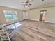 Spacious living room featuring wood-look floors and vaulted ceilings at 9285 Se Highway 42, Summerfield, FL 34491