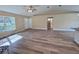Spacious open-plan living area with hardwood floors, a ceiling fan, and natural light at 9285 Se Highway 42, Summerfield, FL 34491