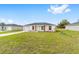 Charming single-story home with a well-manicured front lawn and a driveway leading to the garage at 14363 Sw 27 St, Ocala, FL 34481
