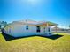 Well-maintained backyard with lush green grass, a covered patio, and a serene outdoor space for relaxation at 3106 Ne 46Th Ave, Ocala, FL 34470