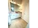Bathroom features double sink vanity with granite countertop and white cabinets at 3106 Ne 46Th Ave, Ocala, FL 34470