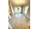 Bright dining room with tile floors, modern chandelier, and large windows offering ample natural light at 3106 Ne 46Th Ave, Ocala, FL 34470