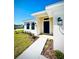 Inviting front entrance featuring a well-lit walkway, manicured landscaping, and a stylish black front door at 3106 Ne 46Th Ave, Ocala, FL 34470