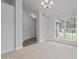 Bright living room featuring neutral walls, carpet, and a large window offering natural light at 3106 Ne 46Th Ave, Ocala, FL 34470