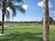 Lakeside backyard with small dock and bench at 5162 Harbour Dr, Oxford, FL 34484