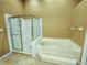 Bathroom featuring step up jacuzzi tub and stand up shower at 5162 Harbour Dr, Oxford, FL 34484