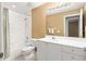Bright bathroom features a white vanity, ample lighting, and a shower-tub combination at 5162 Harbour Dr, Oxford, FL 34484