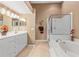 Primary bathroom featuring a jacuzzi tub and a stand-up shower at 5162 Harbour Dr, Oxford, FL 34484
