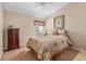 Cozy bedroom features a floral comforter, matching curtains, and traditional furniture at 5162 Harbour Dr, Oxford, FL 34484