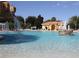 Beautiful community pool featuring waterfall feature, seating, and tennis court at 5162 Harbour Dr, Oxford, FL 34484