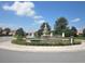 Community entrance with circular fountain and landscaping at 5162 Harbour Dr, Oxford, FL 34484