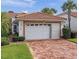 Charming home featuring a two-car garage, brick driveway, and a Spanish tile roof at 5162 Harbour Dr, Oxford, FL 34484