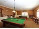 Enjoy this fun game room including a pool table, bar stools, and window at 5162 Harbour Dr, Oxford, FL 34484