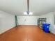 Spacious garage with painted floor, storage shelving, and ladder at 5162 Harbour Dr, Oxford, FL 34484