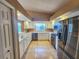 Bright kitchen featuring white cabinets, stainless steel appliances, and tiled flooring at 5162 Harbour Dr, Oxford, FL 34484