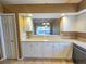 Kitchen view with white cabinets and view into living area at 5162 Harbour Dr, Oxford, FL 34484