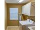 Laundry room with washer, dryer, cabinets, and window at 5162 Harbour Dr, Oxford, FL 34484