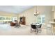 Open-concept living room boasts vaulted ceilings, dining area, and access to the lanai at 5162 Harbour Dr, Oxford, FL 34484