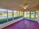 Bright sunroom with ceiling fan, large windows, and lovely water view at 5162 Harbour Dr, Oxford, FL 34484