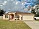 Charming one-story home with a two-car garage and a well-manicured front lawn at 8335 Se 162Nd Pl, Summerfield, FL 34491
