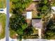 Aerial view of property featuring lush surrounding greenery and a private drive at 12805 Sw 64Th Ln, Ocala, FL 34481