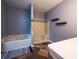 Bathroom featuring tile floors, separate bathtub and shower, and neutral walls at 12805 Sw 64Th Ln, Ocala, FL 34481