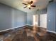 Bedroom featuring neutral walls, tile floors, a ceiling fan, and natural light from one window at 12805 Sw 64Th Ln, Ocala, FL 34481